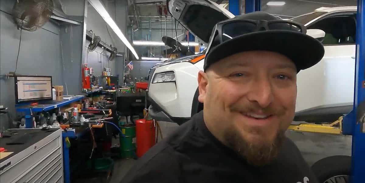 Faruk Kugay standing in North Bay Nissan shop area