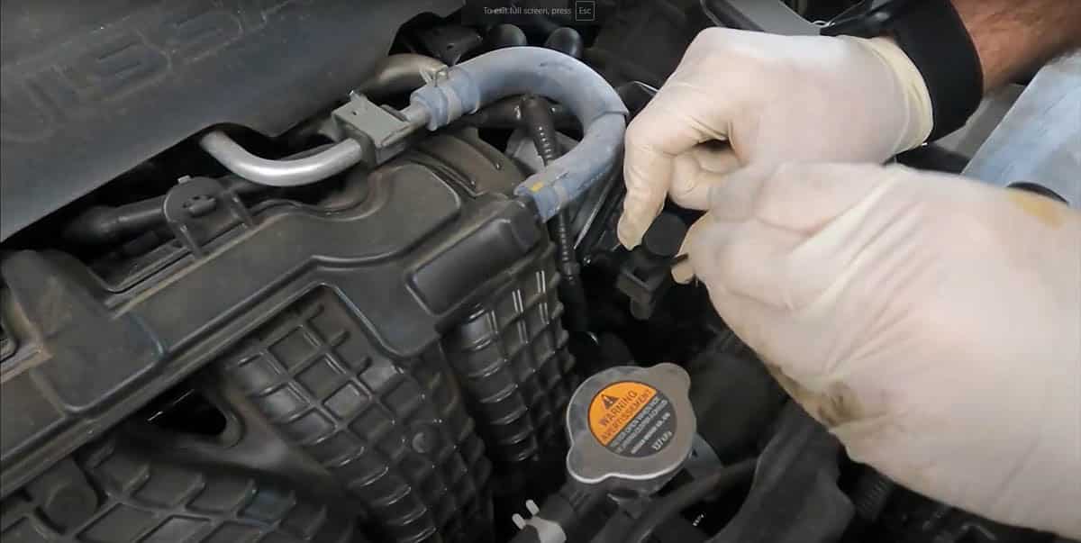 Tommy demonstrating dipstick cap removal on Nissan Altima