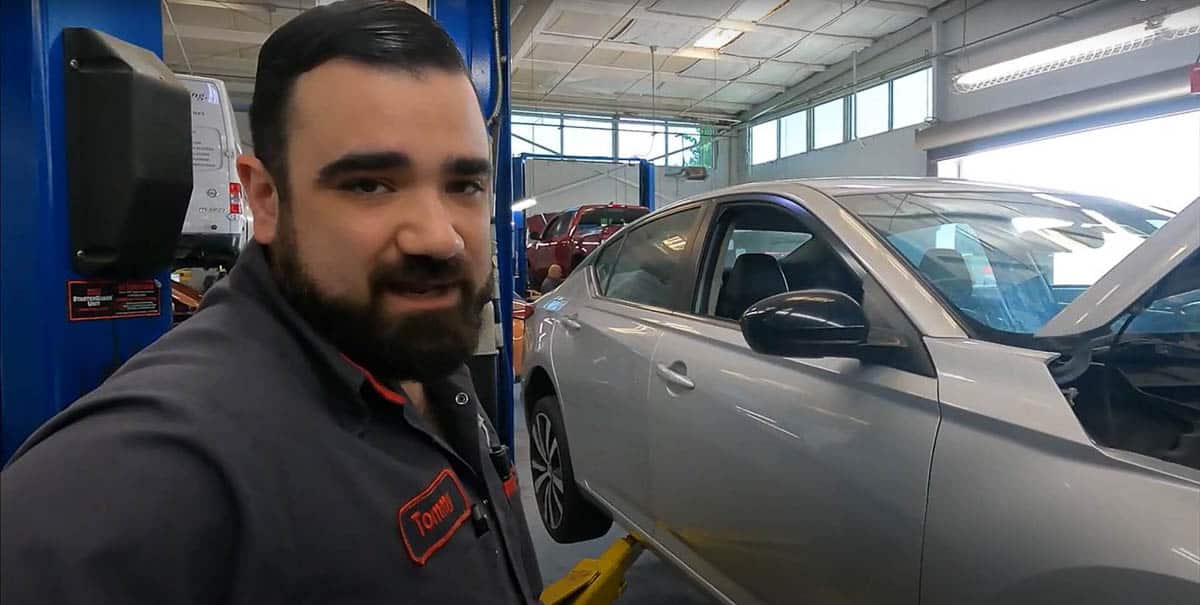 Tommy putting 2020 Nissan Altima back up on lift to finish service