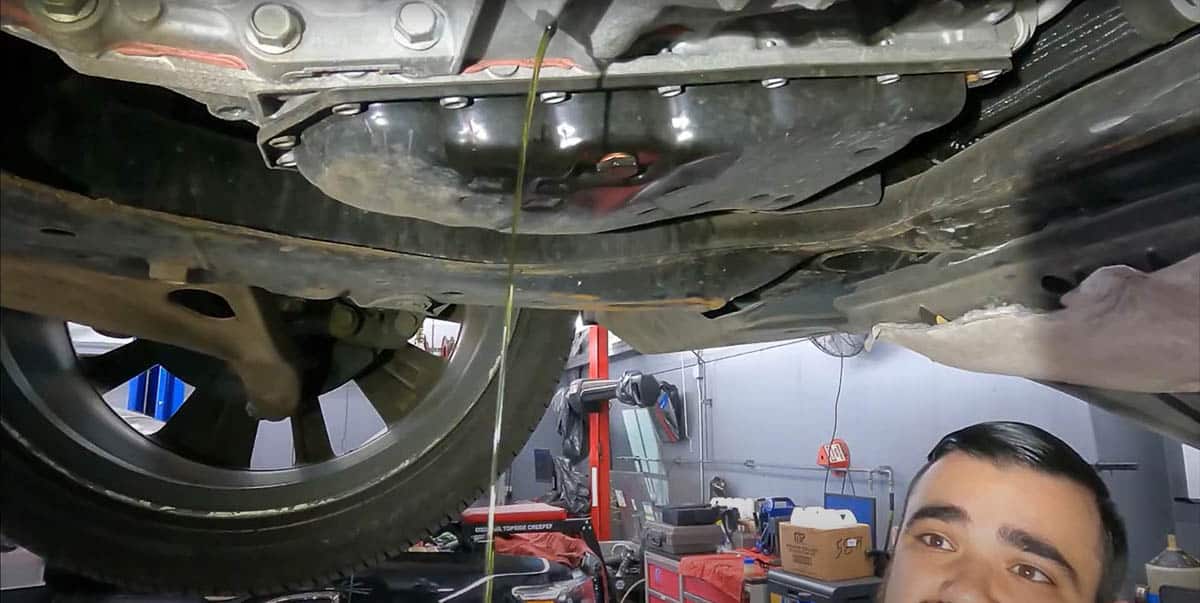 Tommy observing the draining CVT fluid from Nissan Altima