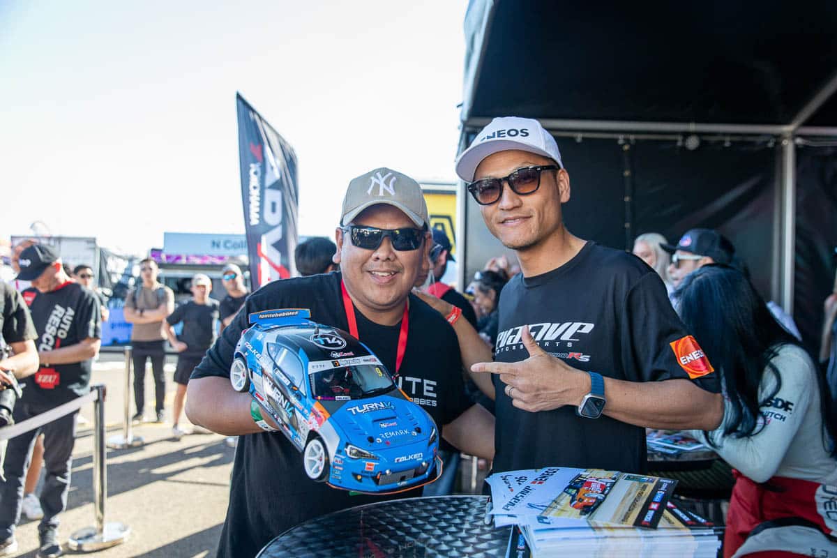 Dai signing his limited edition PRO BRZ R/C car for a fan, 2024 World Time Attack Challenge